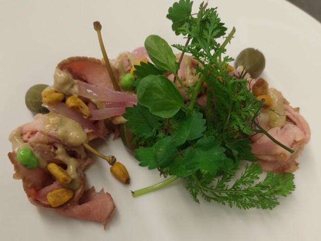 A well presented dish of roast beef on a plate